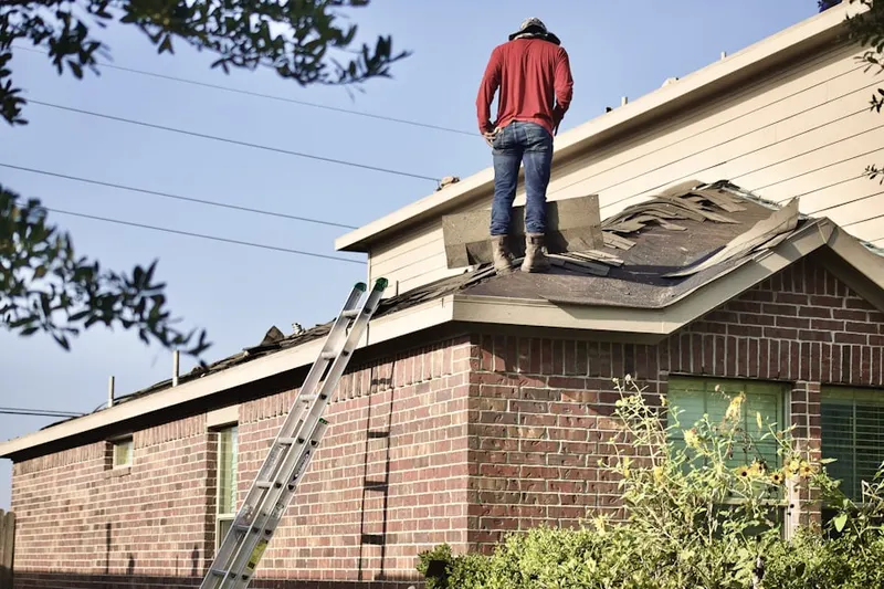 Professional roofer working on a residential roof in College Park Country Estates